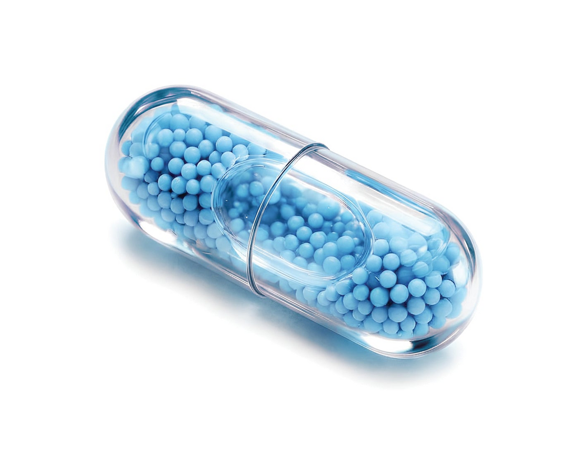 MicroCore capsule: a clear capsule filled with hundreds of tiny blue beadlets