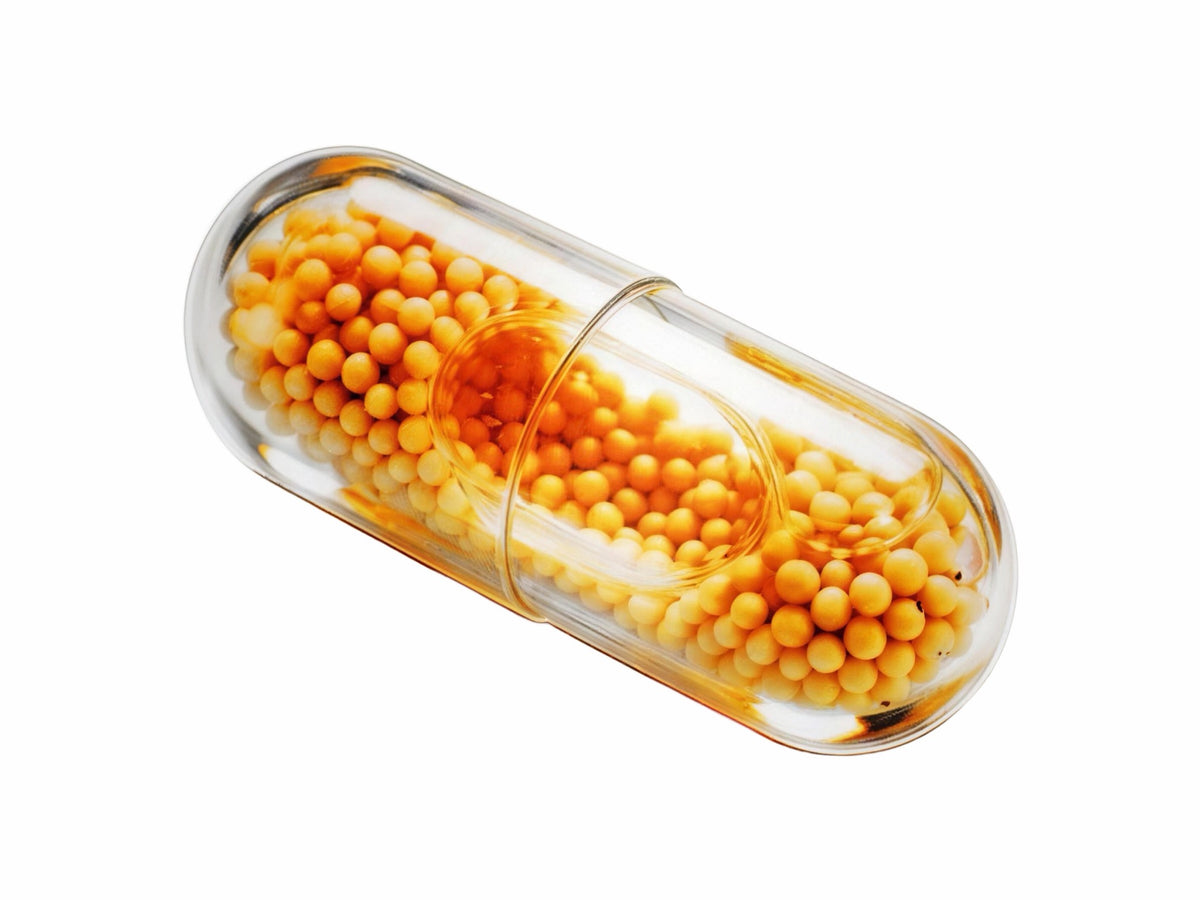 LiquiNova Liver Support+ MicroCore capsule on white, amber microbeadlets in a clear shell