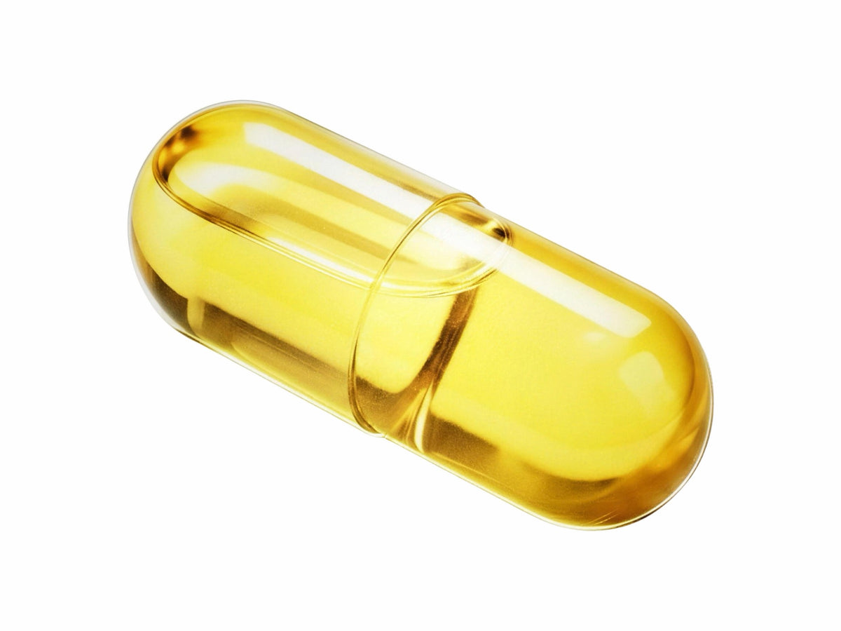 LiquiNova Omega-3 Fish Oil Licaps capsule on white, golden fish oil sealed inside