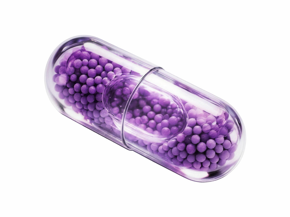 LiquiNova Stress Less MicroCore capsule on white, lavender microbeadlets in a clear shell